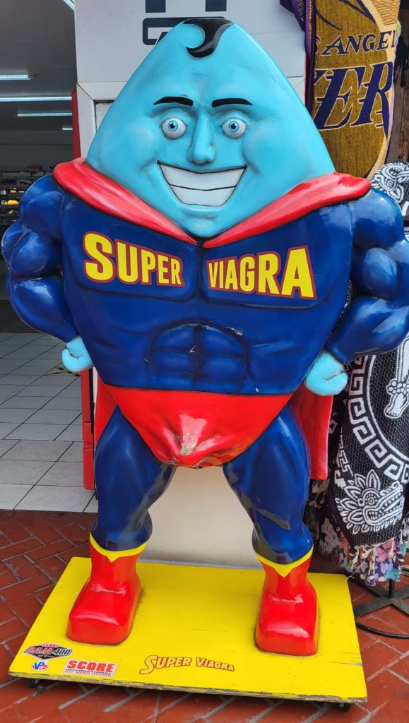 A statue of a superhero named "Super Viagra." It's a giant blue pill with a face in a Superman-esque leotard and cape.