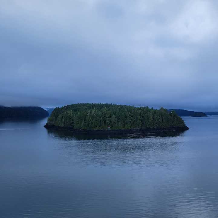 A gorgeous little green island on the sailing from Vancouver to Alaska on cruiseobsessed.com.